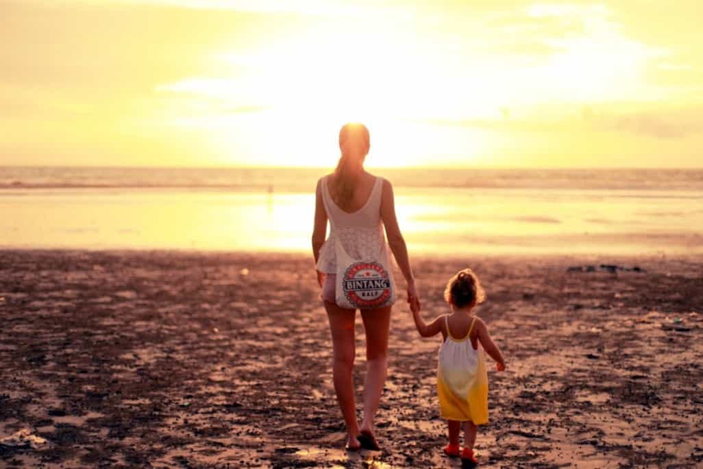 photo of a single mom who would like to date walking with her child 